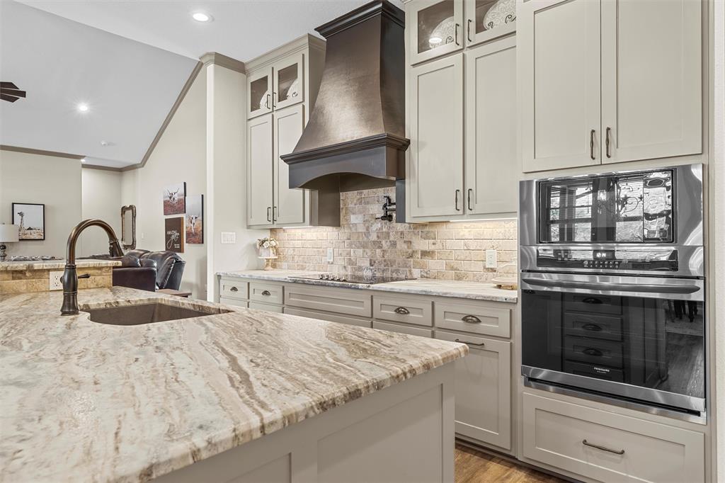 18503 Wortham Bend Road China Spring, TX 76633 - Photo 12 of 40 a kitchen with stainless steel appliances granite countertop a stove a sink and a microwave