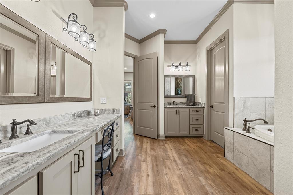 18503 Wortham Bend Road China Spring, TX 76633 - Photo 23 of 40 a bathroom with a granite countertop double vanity sink a mirror and a shower