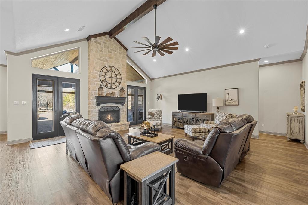 18503 Wortham Bend Road China Spring, TX 76633 - Photo 9 of 40 a living room with furniture a fireplace and a flat screen tv