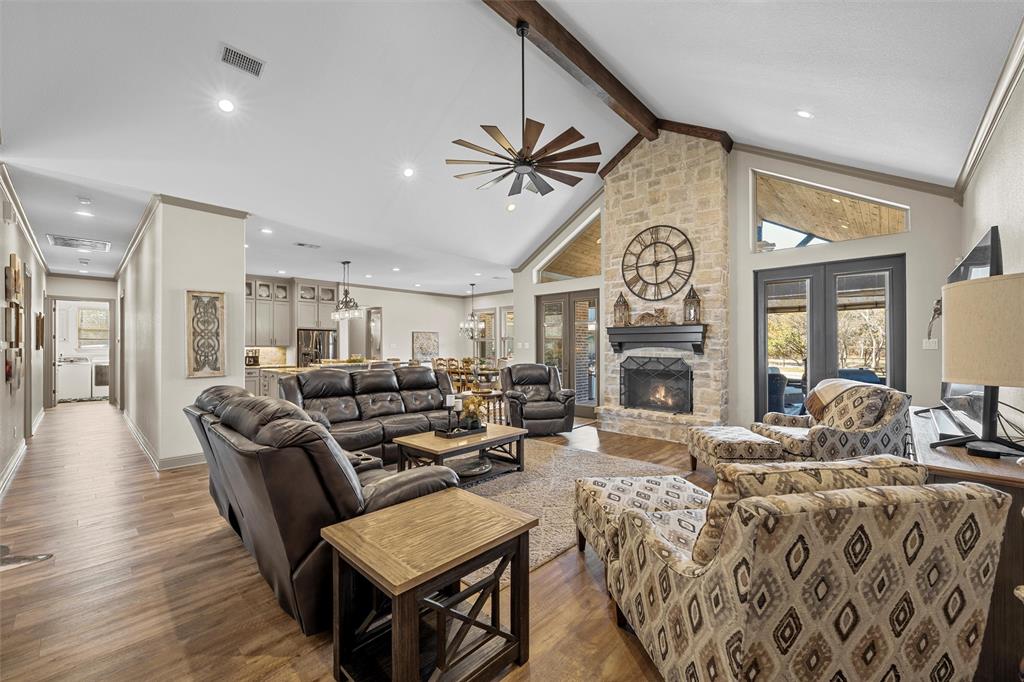 18503 Wortham Bend Road China Spring, TX 76633 - Photo 10 of 40 a living room with fireplace furniture and a chandelier