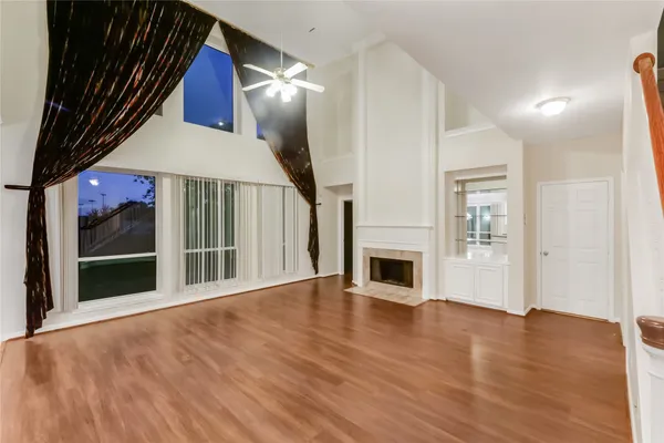 wooden floor in an empty room with a fireplace
