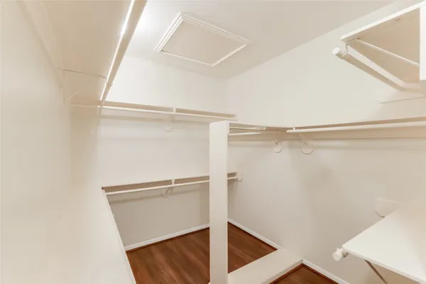 a view of walk in closet with empty racks