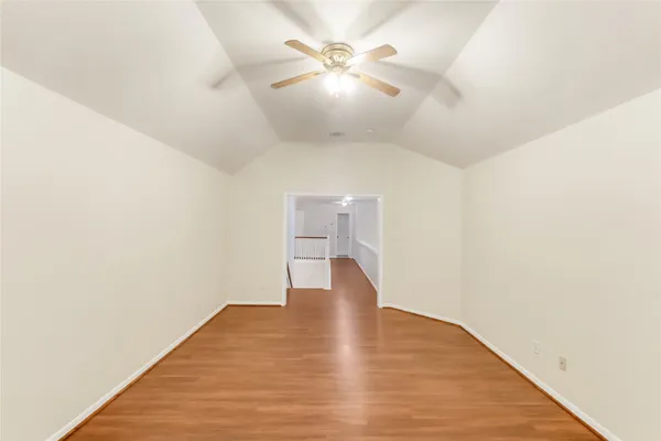 a view of a room with wooden floor
