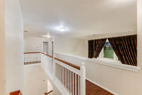 a view of a room with wooden floor and windows