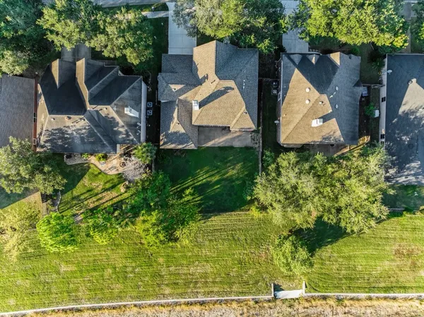 an aerial view of a house with swimming pool garden and patio