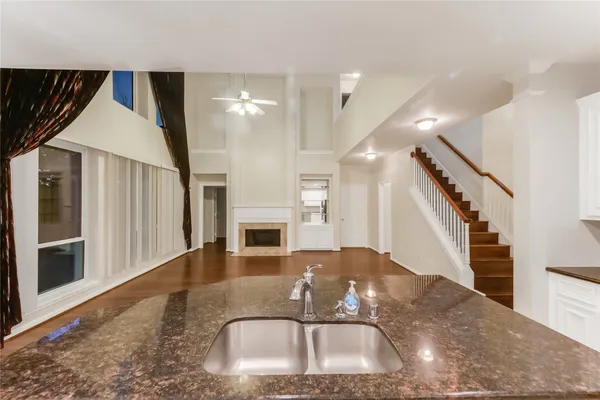 a kitchen with stainless steel appliances kitchen island granite countertop a refrigerator and a stove top oven