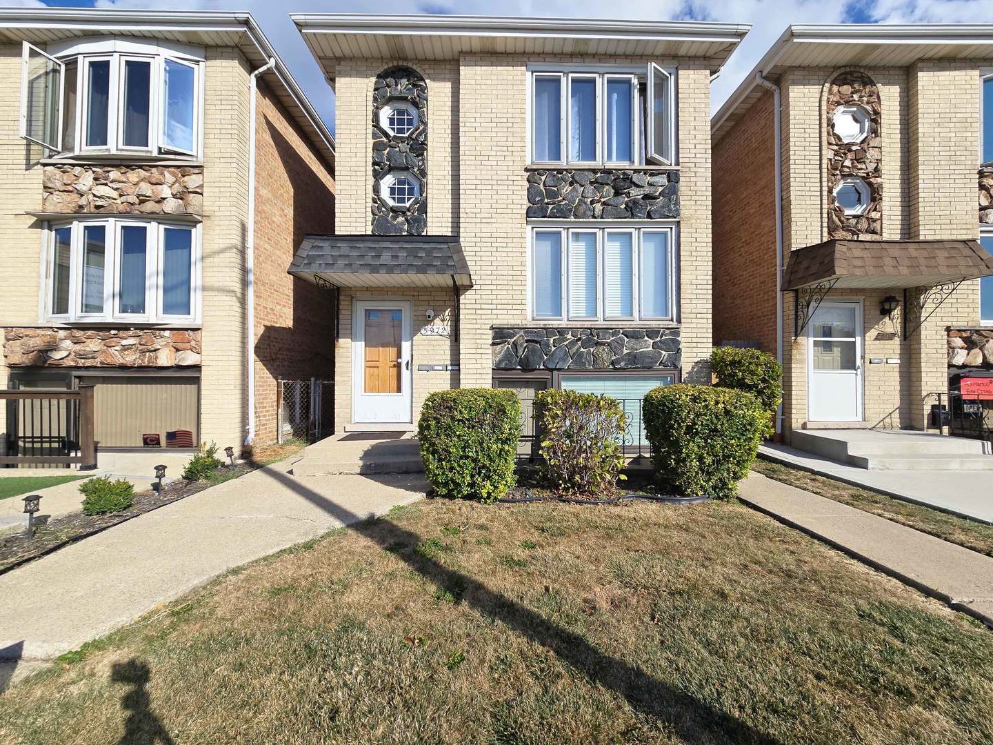 a front view of a brick house with many windows