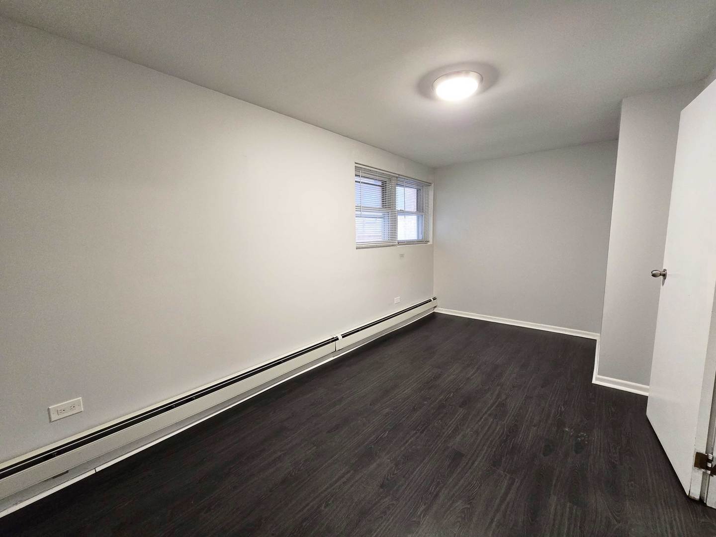 5972 South Archer Avenue, Unit GN Chicago, IL 60638 - Photo 14 of 16 an empty room with wooden floor and windows