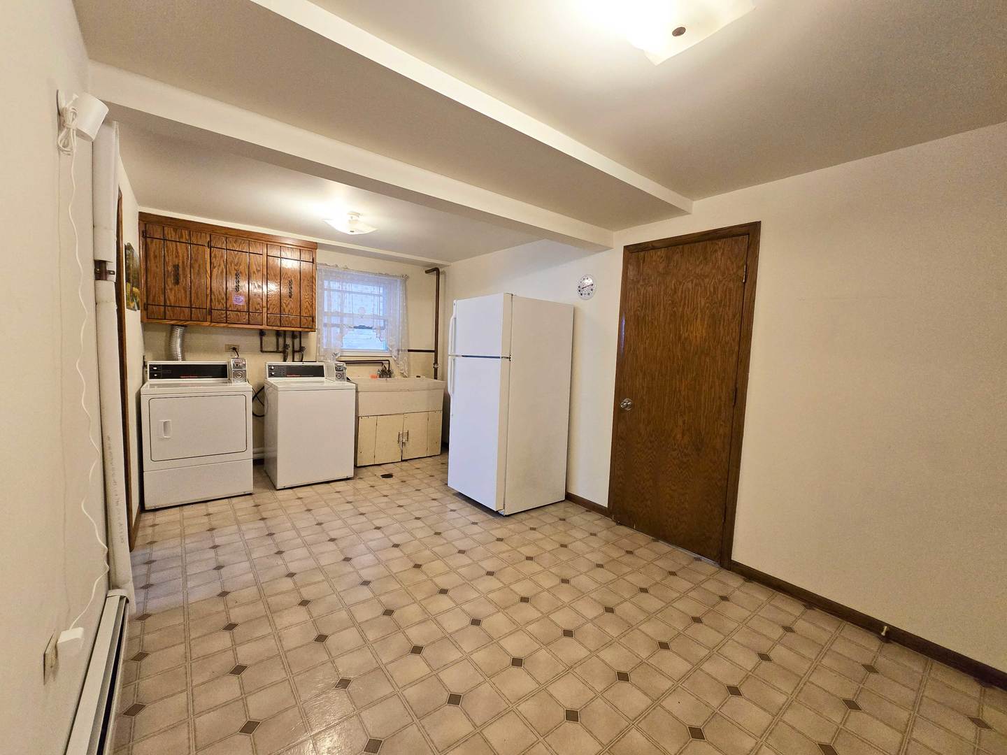 5972 South Archer Avenue, Unit GN Chicago, IL 60638 - Photo 15 of 16 a kitchen with a refrigerator a stove top oven and white cabinets