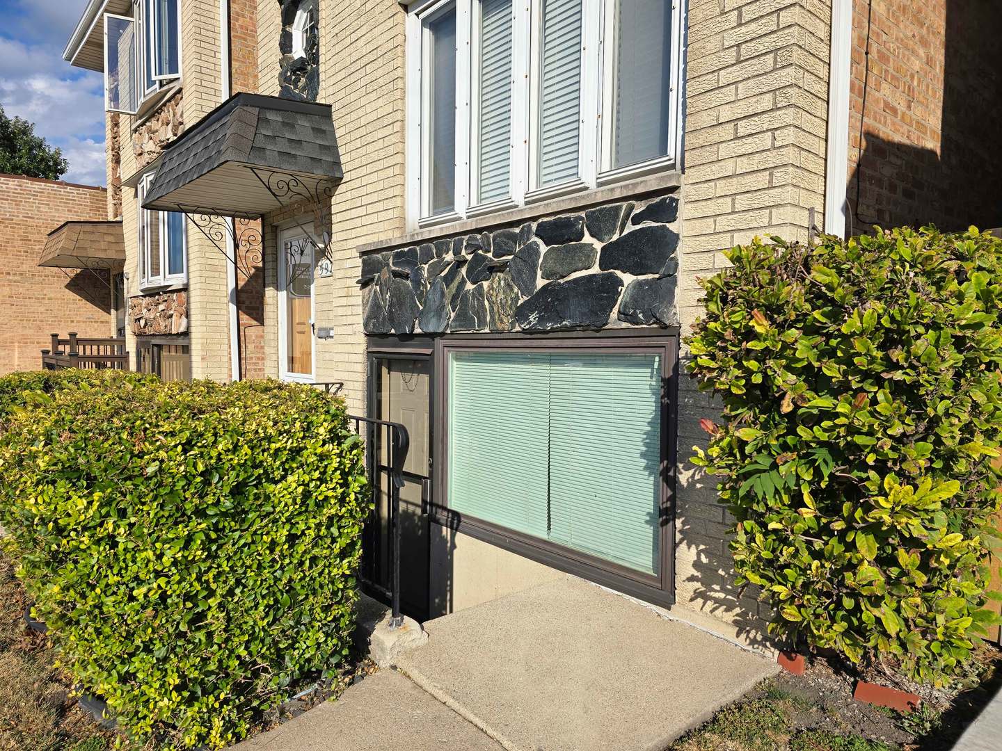 5972 South Archer Avenue, Unit GN Chicago, IL 60638 - Photo 2 of 16 a potted plant sitting in front of a house