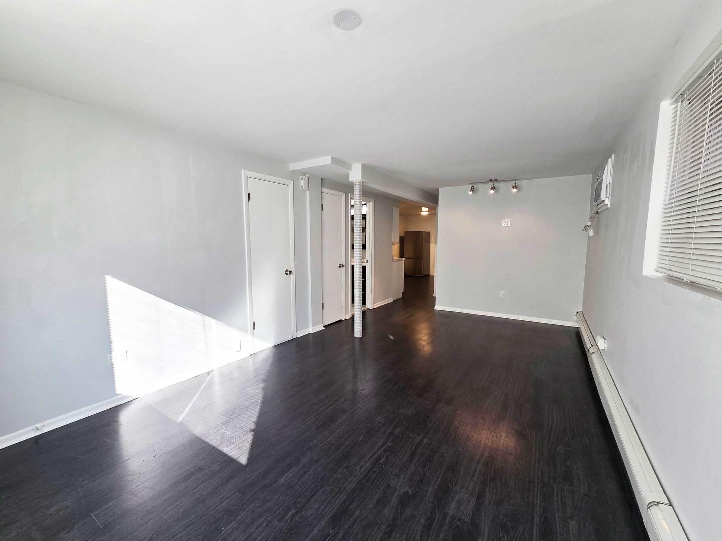 5972 South Archer Avenue, Unit GN Chicago, IL 60638 - Photo 4 of 16 a view of an empty room with wooden floor and a window