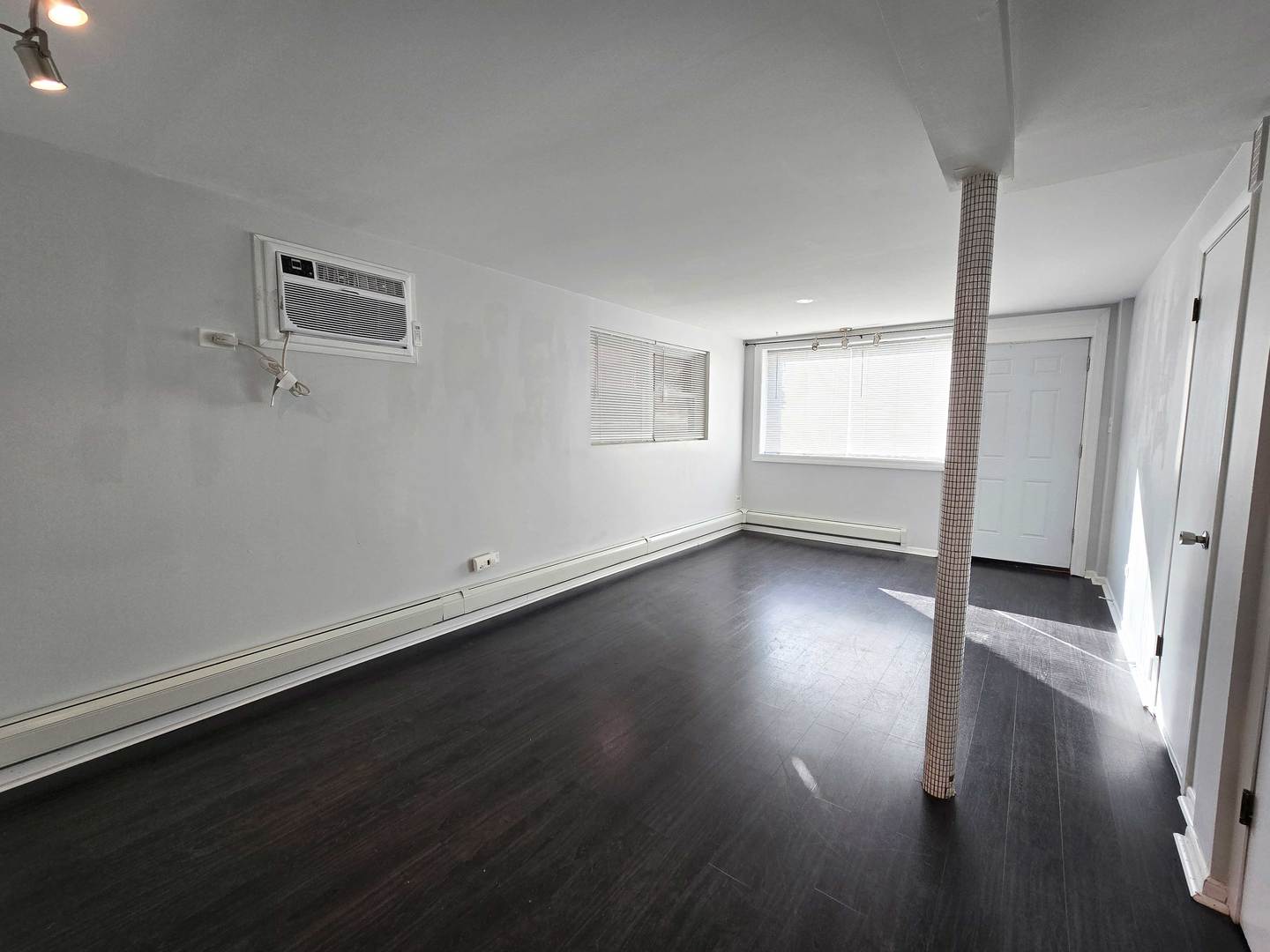 5972 South Archer Avenue, Unit GN Chicago, IL 60638 - Photo 5 of 16 an empty room with wooden floor and windows