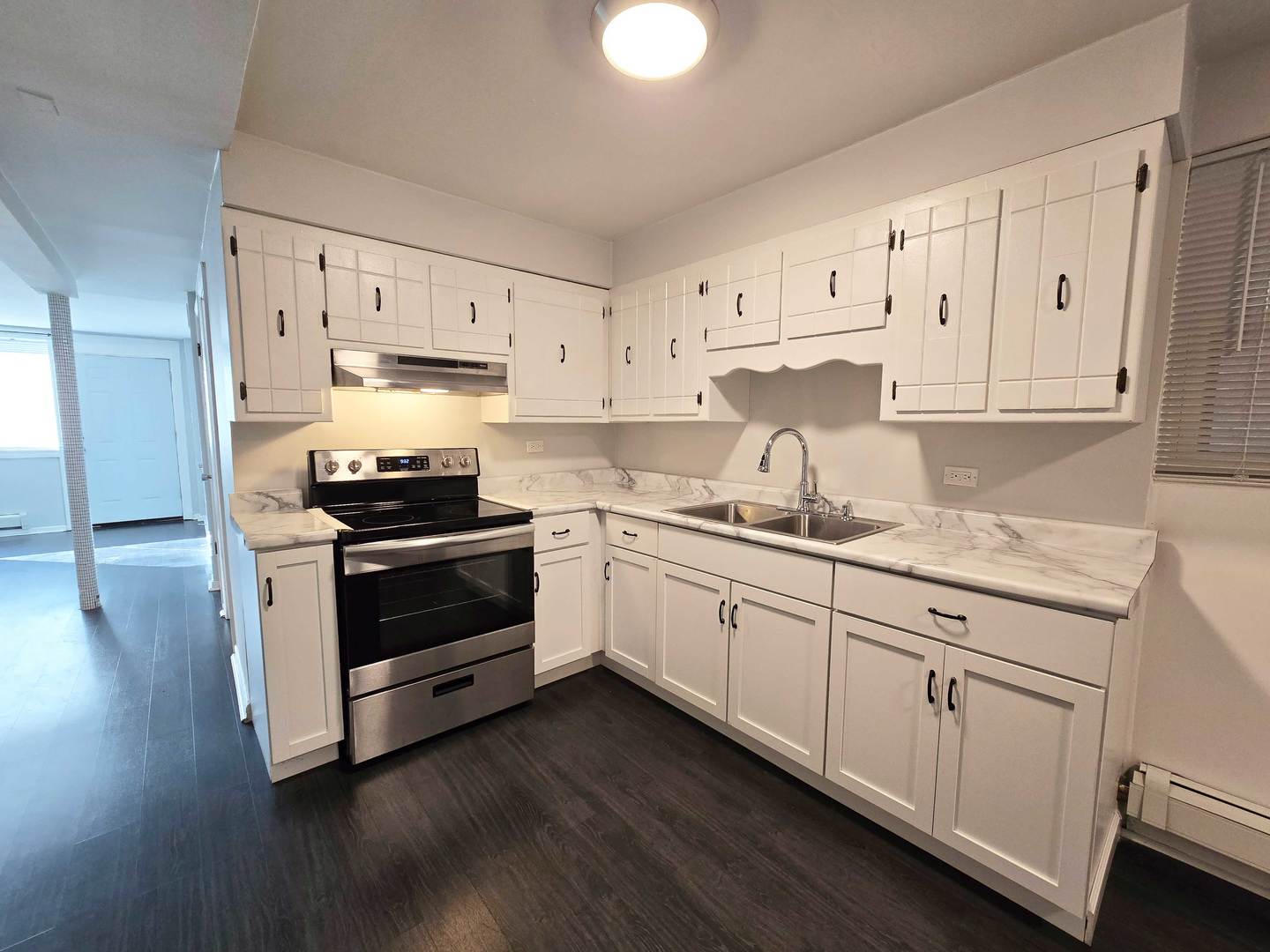 5972 South Archer Avenue, Unit GN Chicago, IL 60638 - Photo 7 of 16 a kitchen with granite countertop white cabinets and stainless steel appliances