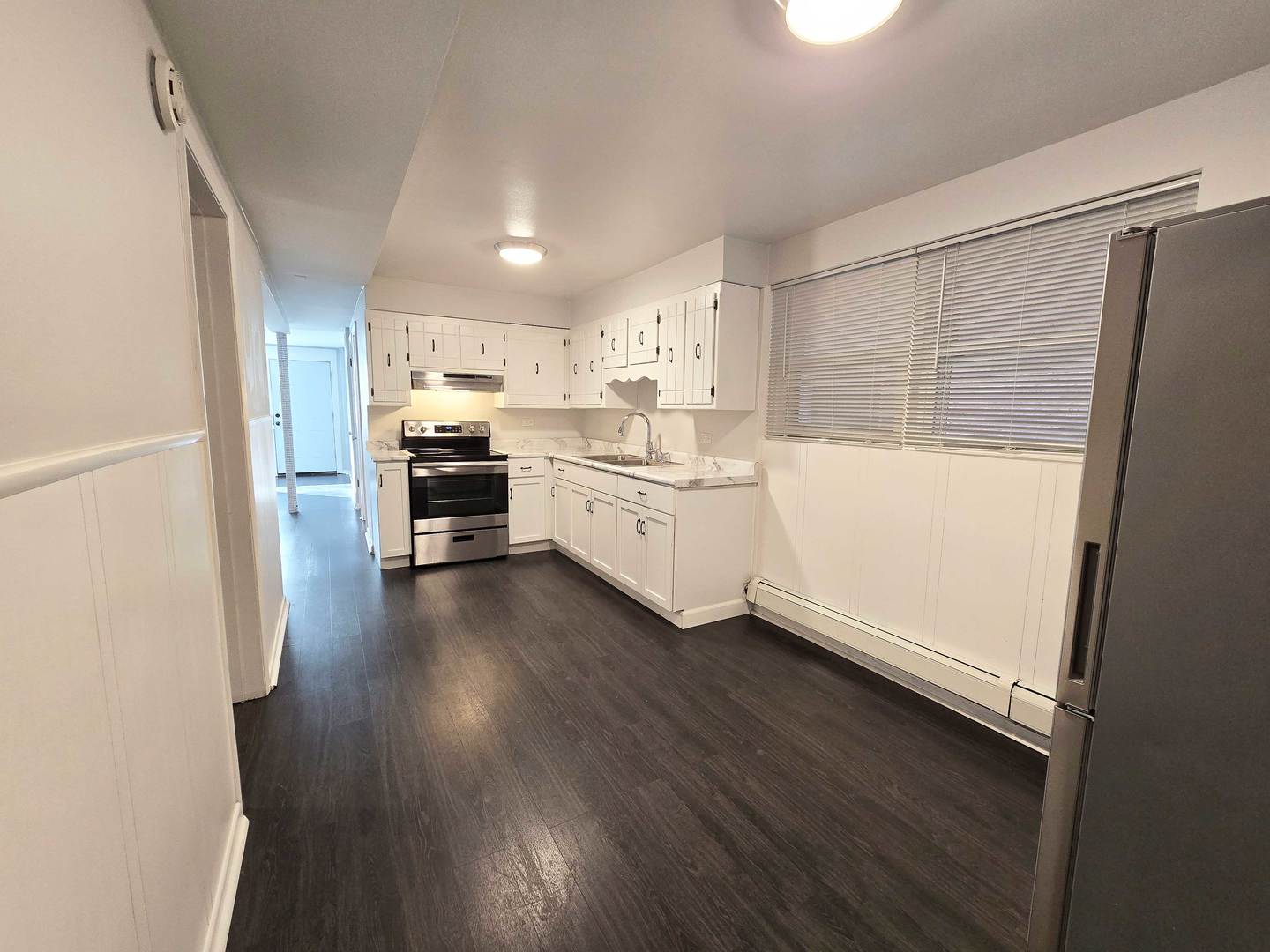 5972 South Archer Avenue, Unit GN Chicago, IL 60638 - Photo 8 of 16 a kitchen with cabinets a sink and wooden floor