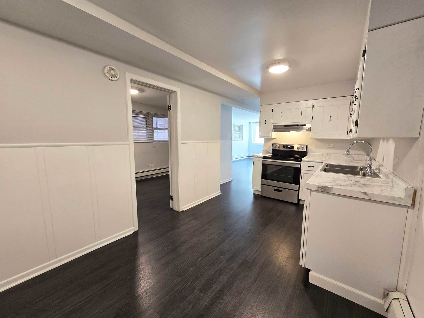 5972 South Archer Avenue, Unit GN Chicago, IL 60638 - Photo 9 of 16 a kitchen with wooden floor and electronic appliances