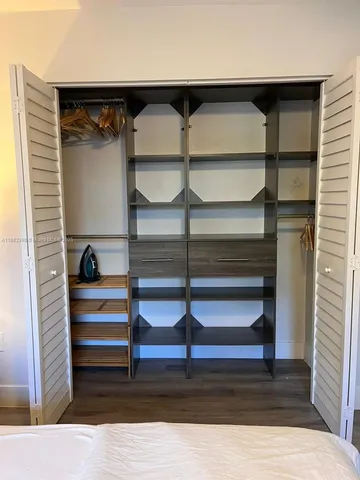 a bedroom with a bed and a lamp