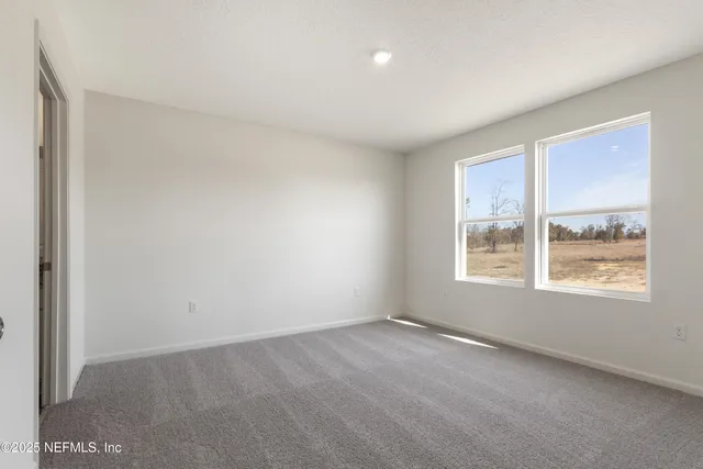 a bathroom with a granite countertop sink a toilet and a mirror