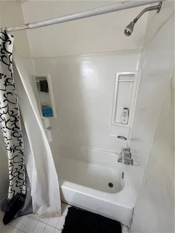 a bathroom with a tub a sink and a shower