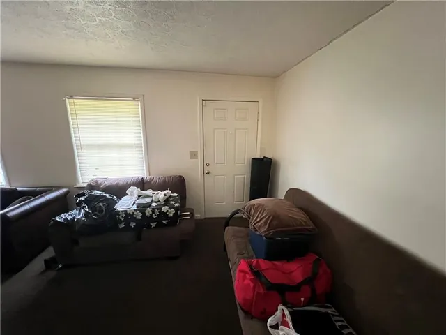 a bed sitting in a bedroom next to a window