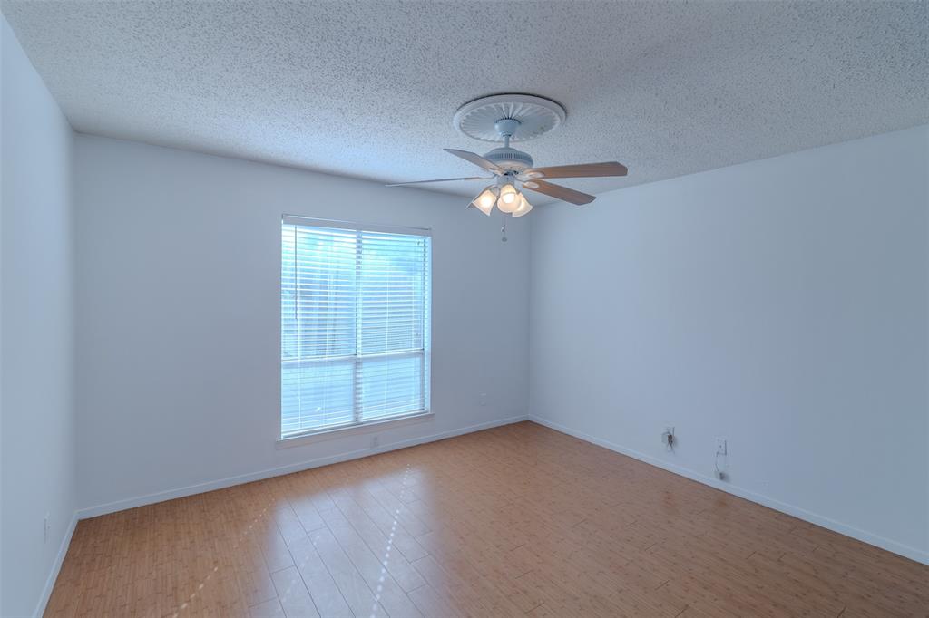 4859 Cedar Springs Road, Unit 234 Dallas, TX 75219 - Photo 12 of 22 an empty room with a chandelier fan and windows