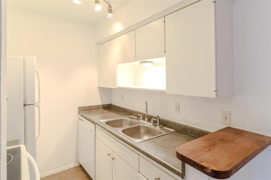 4859 Cedar Springs Road, Unit 234 Dallas, TX 75219 - Photo 14 of 22 a kitchen with a sink a stove and a refrigerator