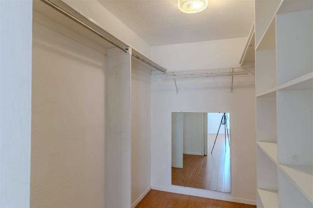 4859 Cedar Springs Road, Unit 234 Dallas, TX 75219 - Photo 15 of 30 a view of walk in closet with wooden floor
