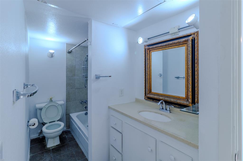 4859 Cedar Springs Road, Unit 234 Dallas, TX 75219 - Photo 18 of 30 a bathroom with a granite countertop sink toilet and shower