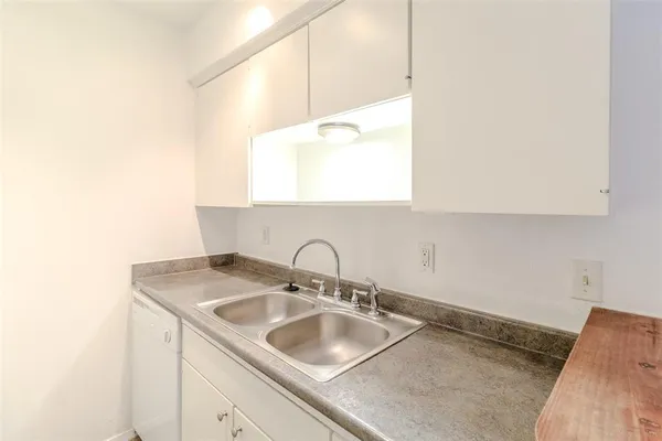 a kitchen with a sink cabinets and window