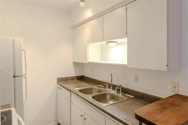 a kitchen with a sink a stove and a refrigerator