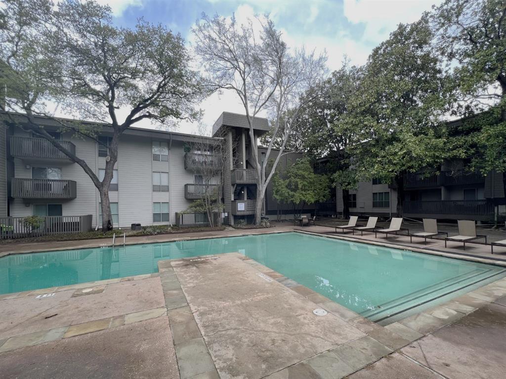 4859 Cedar Springs Road, Unit 234 Dallas, TX 75219 - Photo 22 of 22 a view of a house with swimming pool and a yard
