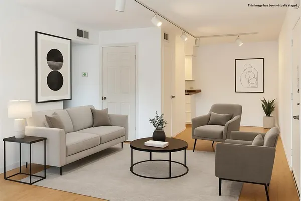 a living room with furniture and a wall painting