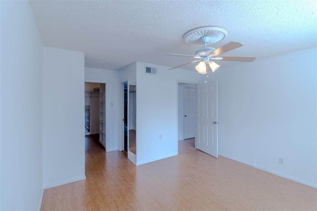 4859 Cedar Springs Road, Unit 234 Dallas, TX 75219 - Photo 9 of 22 a view of an empty room with a chandelier fan