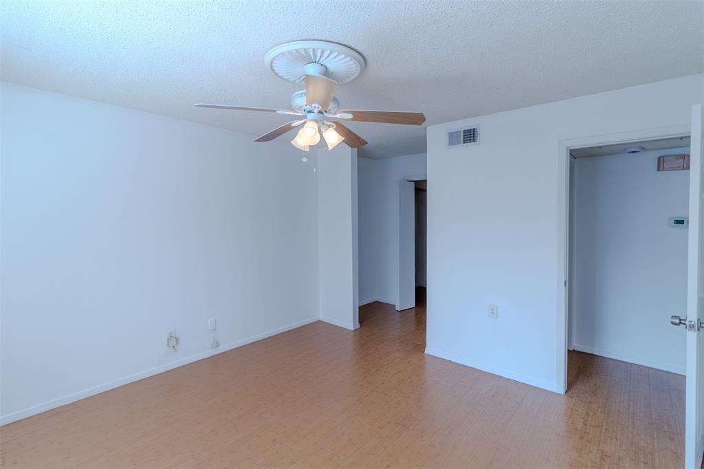4859 Cedar Springs Road, Unit 234 Dallas, TX 75219 - Photo 10 of 22 a view of an empty room with wooden floor