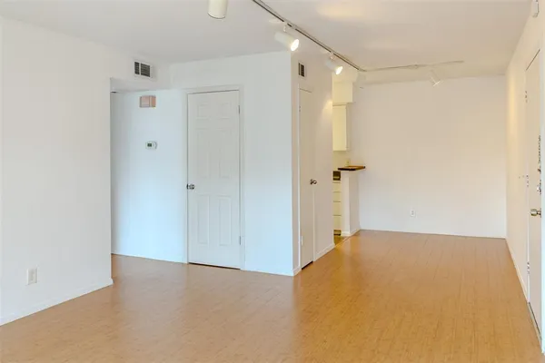 a view of a big room with closet and chandelier fan