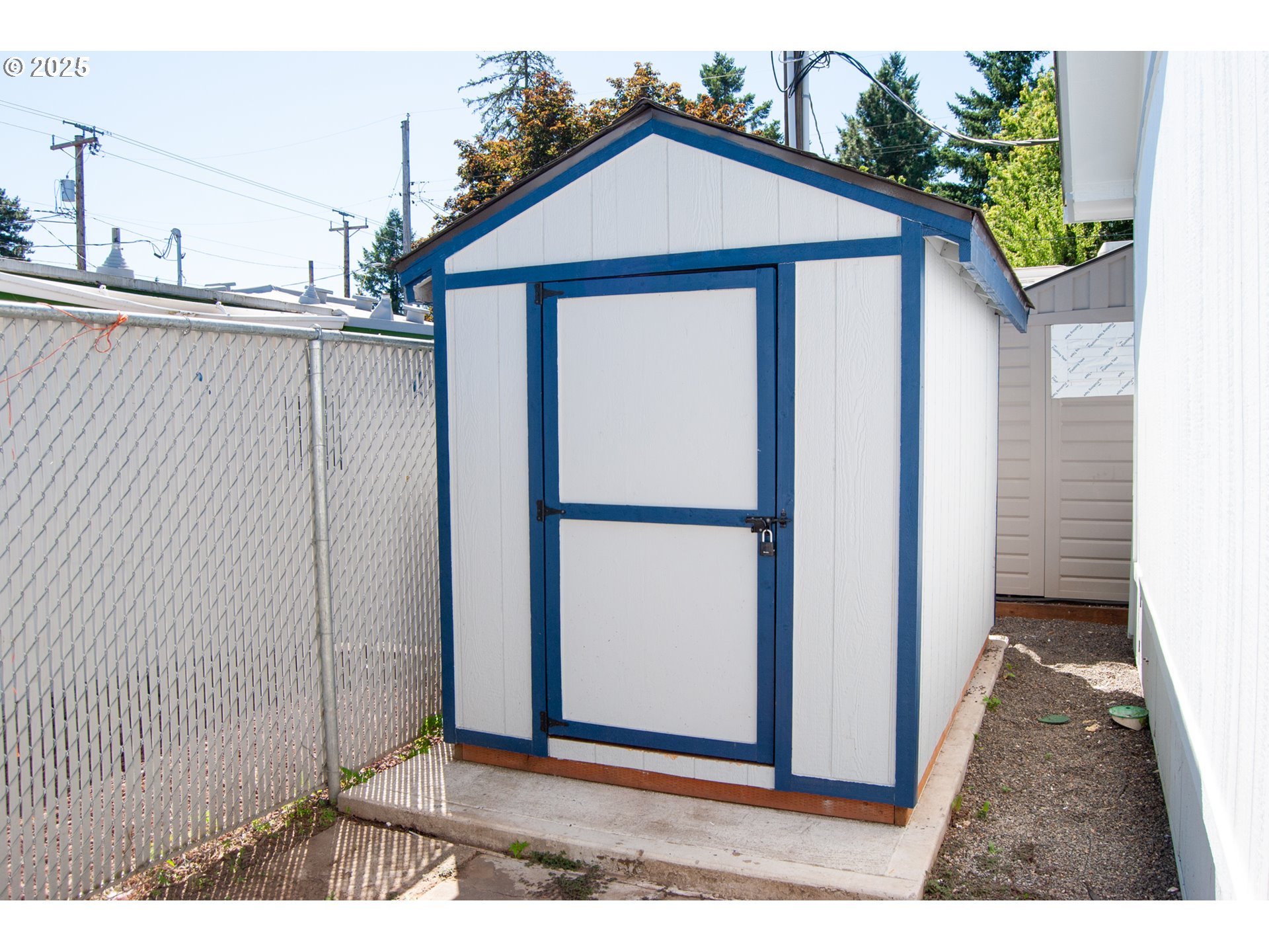 10901 Southeast Powell Boulevard, Unit 33 Portland, OR 97266 - Photo 12 of 12 a view of a wooden house with a small yard