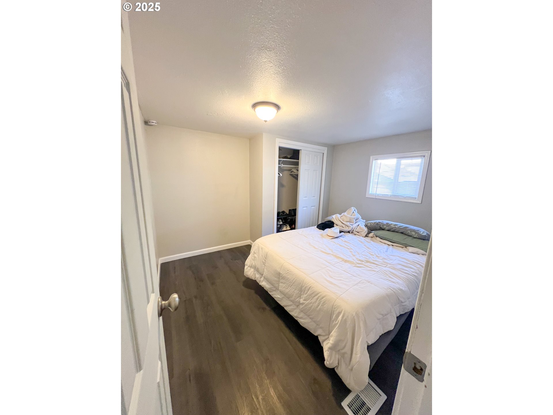 10901 Southeast Powell Boulevard, Unit 33 Portland, OR 97266 - Photo 9 of 12 a bedroom with a bed and a night stand