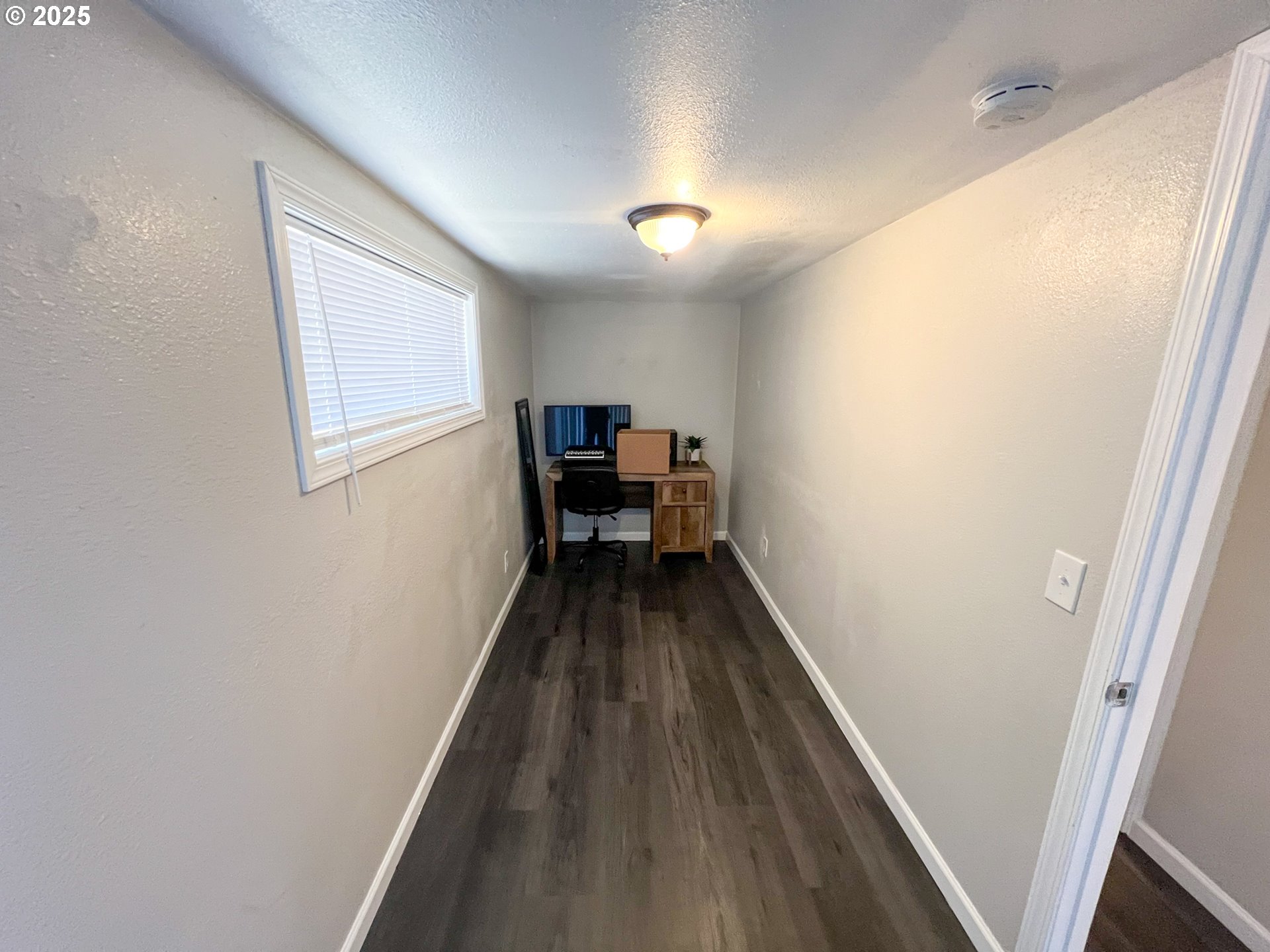10901 Southeast Powell Boulevard, Unit 33 Portland, OR 97266 - Photo 10 of 12 a view of a hallway with wooden floor and furniture