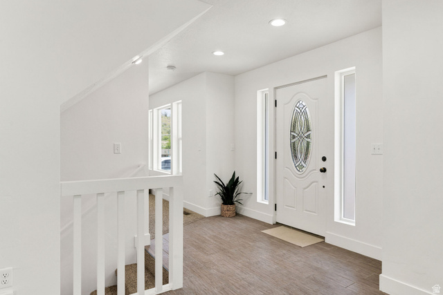 1552 Sumac Drive Logan, UT 84321 - Photo 2 of 72 Entryway featuring a white door with decorative glass, flanked by two vertical windows