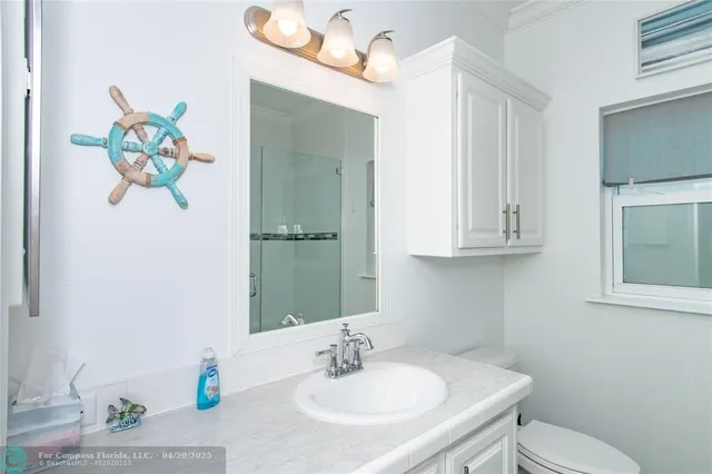 a bathroom with a sink mirror and vanity