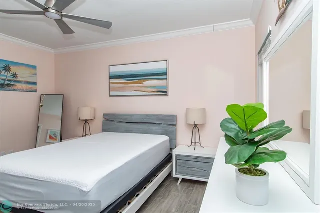 a bedroom with a bed and a potted plant