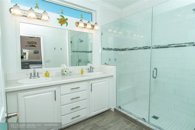 a bathroom with a sink mirror and vanity