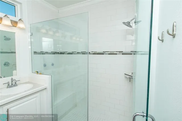 a bathroom with a shower and a sink