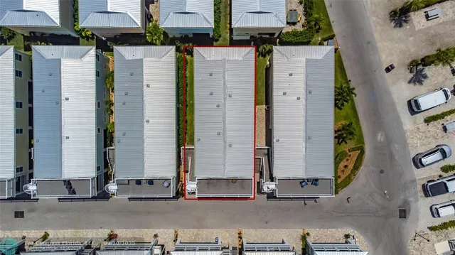an aerial view of a house with patio and outdoor seating