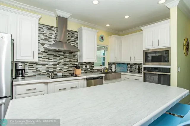 a kitchen with stainless steel appliances a stove sink and cabinets