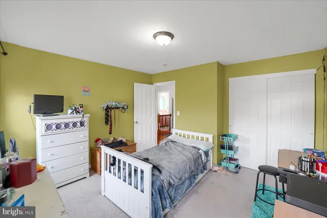 a bedroom with a bed and a desk