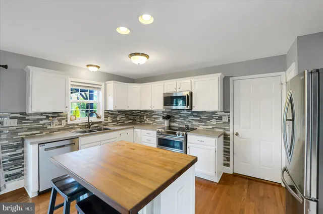 a kitchen with a sink stove and microwave