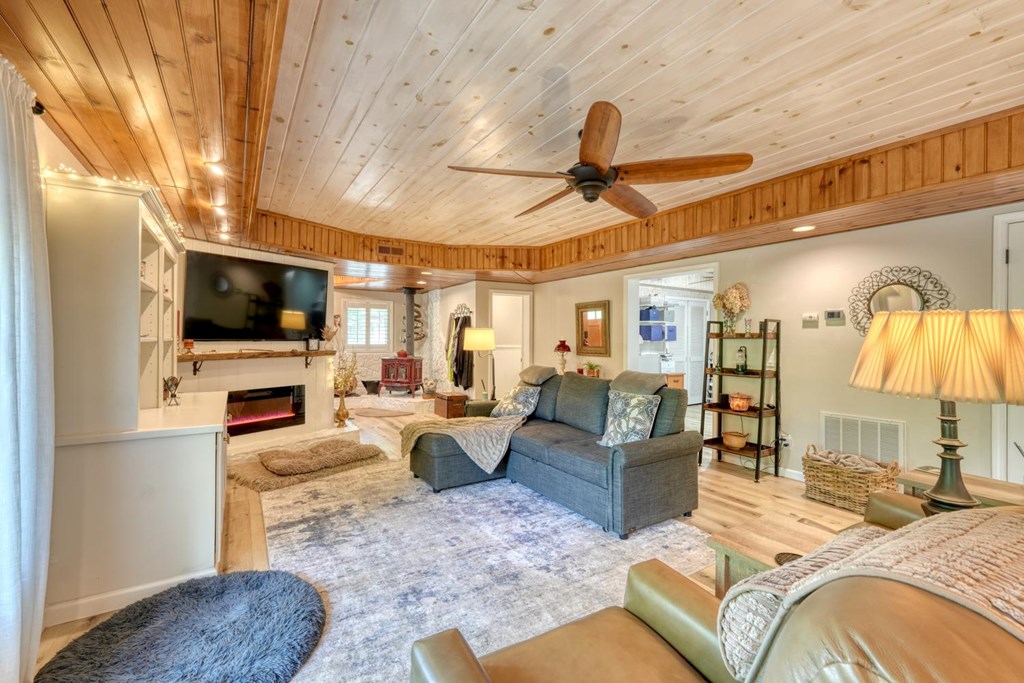 710 Town Mountain Road Hayesville, NC 28904 - Photo 26 of 68 a living room with fireplace furniture and a flat screen tv