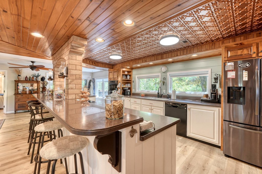 710 Town Mountain Road Hayesville, NC 28904 - Photo 33 of 68 a kitchen with stainless steel appliances granite countertop table chairs and large window