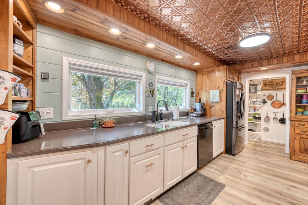 710 Town Mountain Road Hayesville, NC 28904 - Photo 40 of 68 a kitchen with stainless steel appliances granite countertop a sink window and cabinets