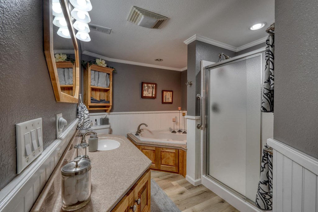 710 Town Mountain Road Hayesville, NC 28904 - Photo 41 of 68 a bathroom with a granite countertop sink a mirror a bathtub and shower